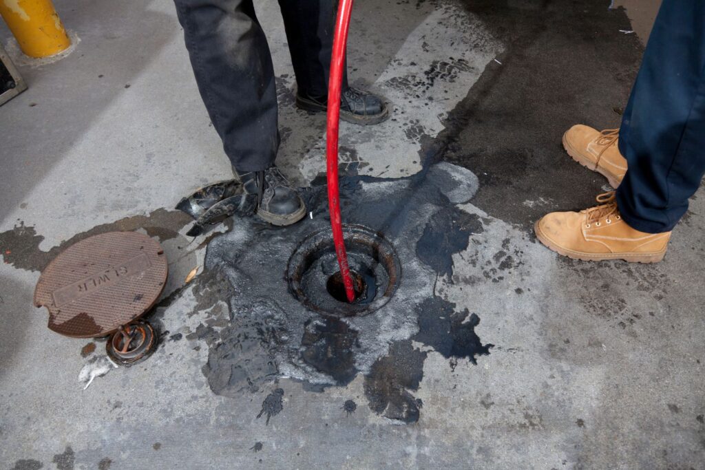 Sewer jetting red pipe in a drain